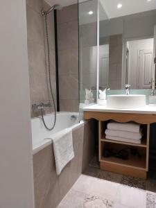 a bathroom with a tub and a sink at Disneyland Paris perfect for 5 ! in Serris