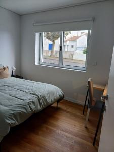 a bedroom with a bed and a window at Azure Escape Azores in Arrifes