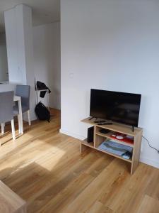 a living room with a flat screen tv on a stand at Azure Escape Azores in Arrifes