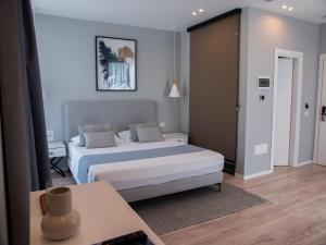 a bedroom with a bed and a table in a room at Dukes Albania in Vlorë +44 photos