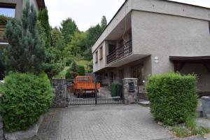 an orange truck is parked in front of a building at Domček pod Kalváriou in Ružomberok