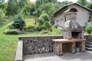 an outdoor oven in a yard with a stone wall at Domček pod Kalváriou in Ružomberok