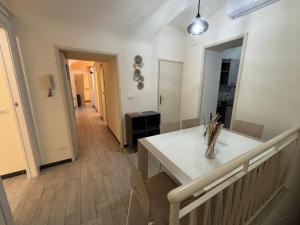 a kitchen with a white table and a hallway at Agata dreams apartment in Catania