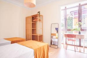 a bedroom with a bed and a desk and a window at The Nest - by Wehomes in Santander