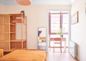 a bedroom with a bed and a table and a chair at The Nest - by Wehomes in Santander
