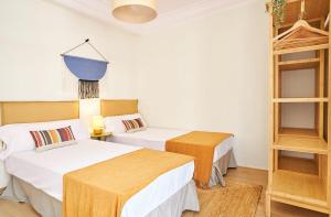 a room with two beds and a shelf at The Nest - by Wehomes in Santander