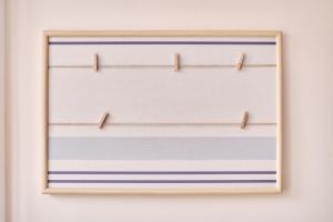 a framed picture of stripes on a wall at The Nest - by Wehomes in Santander