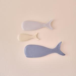 three differently colored whales on a pink background at The Nest - by Wehomes in Santander