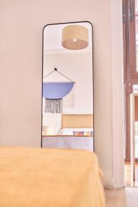 a mirror in a room next to a table at The Nest - by Wehomes in Santander
