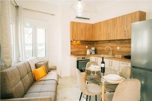 a living room with a couch and a glass table at Aether houses in Mytilene