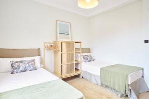 a room with two beds and a mirror at The Nest - by Wehomes in Santander