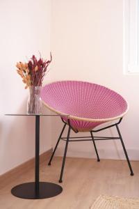a table with a vase of flowers on a table at The Nest - by Wehomes in Santander