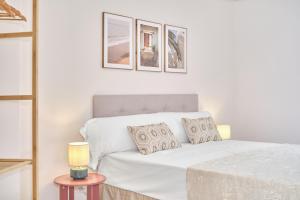 a white couch in a white room with a table at The Nest - by Wehomes in Santander
