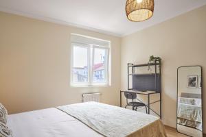 a bedroom with a bed and a desk and a window at The Nest - by Wehomes in Santander