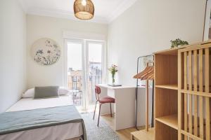 a small bedroom with a bed and a desk at The Nest - by Wehomes in Santander