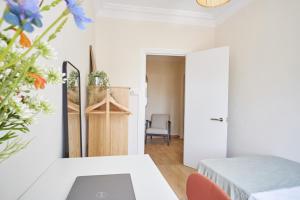 a living room with a table and flowers at The Nest - by Wehomes in Santander