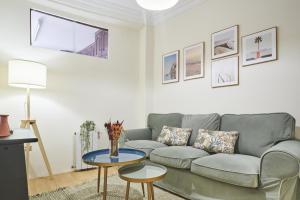 a living room with a couch and a table at The Nest - by Wehomes in Santander