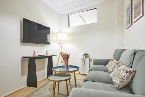 a living room with a couch and a table at The Nest - by Wehomes in Santander