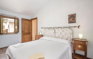 a bedroom with a large white bed and a window at Casa Gelsomino in Narni +21 photos