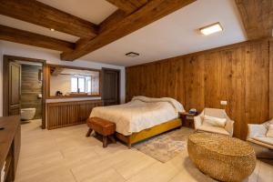 a bedroom with wooden walls and a bed and a chair at Pensiunea Casa Cranta in Braşov