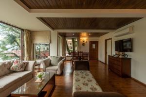 a living room with a couch and a table at Pine Wood 2BHK Apartment Close to Naini Lake in Nainital