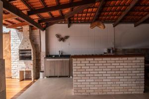 a kitchen with a butterfly hanging on the wall at Recanto das Araras in Pirenópolis