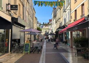 a city street with tables and chairs and buildings at Le Cosy Lagny - Appartement Cosy avec balcon vue sur Marne in Lagny