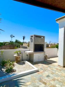 a outdoor patio with a fireplace in a backyard at Premium 2025 Housing with BBQ in Paralimni