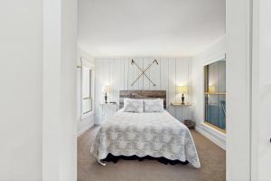 a white bedroom with a bed and a window at North Lynx 11 in Warren