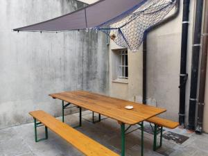 a wooden table and a bench in front of a building at Angolo Del Paradiso in Chioggia