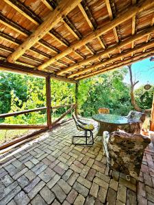 an outdoor patio with a table and chairs at Green Haven Retreat - Nature's peace just for you in Rakovac