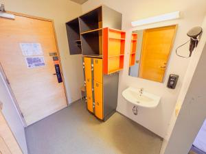 a bathroom with a sink and a mirror at Dalur - HI Eco Hostel in Reykjavík