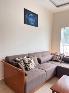 a living room with a gray couch with pillows at Ram Residency chengalpattu in Ottivākkam +6 photos
