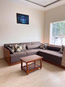 a living room with a couch and a coffee table at Ram Residency chengalpattu in Ottivākkam