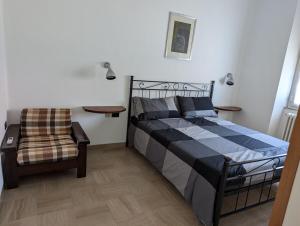 a bedroom with a bed and a chair at Il Pincio Apartment, Cagli in Cagli