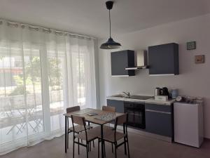 a kitchen with a table and chairs and a kitchen with a window at La Bianca Dimora in Sulmona
