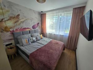 Ένα ή περισσότερα κρεβάτια σε δωμάτιο στο Apartamenty Słoneczna