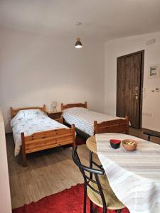 a bedroom with two beds and a table and chairs at Studios Iris in Pramanta +47 photos