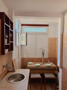 a kitchen with a sink and a table with chairs at Porta Mare Apartment in Bar