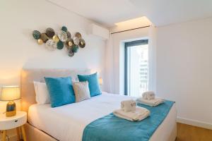 a bedroom with a bed with towels on it at GuestReady - Soothing escape in Funchal in Panasqueira