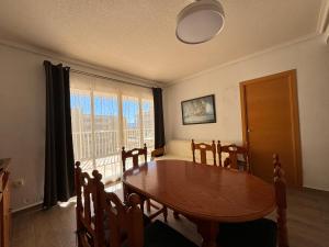 a dining room with a table and a large window at Casablanca in Miramar