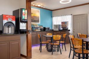 a fast food restaurant with a table and chairs at Days Inn by Wyndham Suites Fredericksburg in Fredericksburg