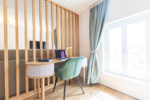 a room with a desk and a chair and a window at Les toits d'Angoulême in Angoulême