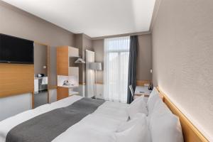 Giường trong phòng chung tại Best Western Plus Hotel Zürcherhof