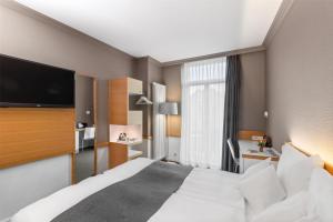Giường trong phòng chung tại Best Western Plus Hotel Zürcherhof