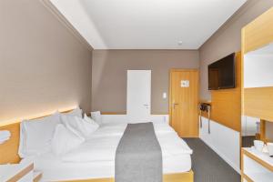 Giường trong phòng chung tại Best Western Plus Hotel Zürcherhof