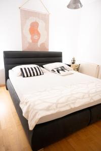 a bedroom with a large bed with white sheets and pillows at The Sun and the Moon in Zadar
