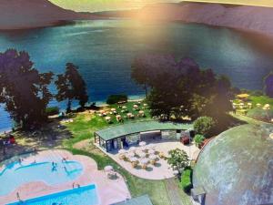 an aerial view of a swimming pool next to the water at suite pure air in Omegna