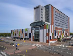 a large building with a street in front of it at Hampton by Hilton Liverpool John Lennon Airport in Speke