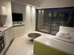 a kitchen with a couch and a chair in a room at G cribs cozy studio in El Gouna